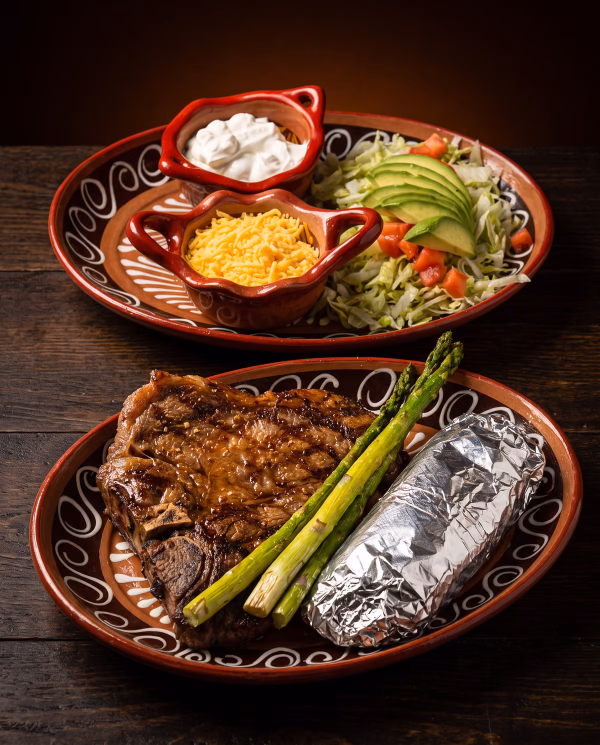 T-bone steak with asparagus, baked potato and avocado