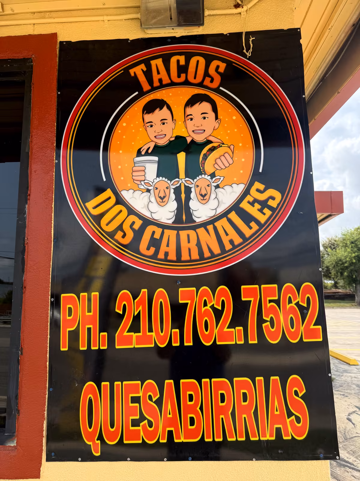 Tacos Dos Carnales storefront banner advertising quesabirrias